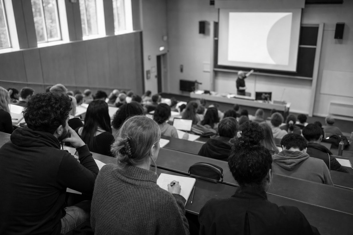 University lecture theatre with adult learners taking notes